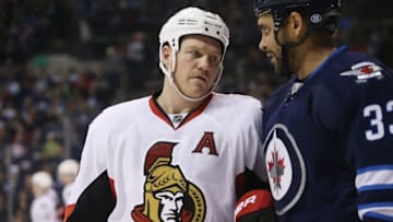 Oct 3, 2016; Winnipeg, Manitoba, CAN; Ottawa Senators defenceman Matt Bartkowski (12) has his shot blocked by Winnipeg Jets defenseman Dustin Byfuglien (33) during the third period at MTS Centre. Winnipeg wins 4-2. Mandatory Credit: Bruce Fedyck-USA TODAY Sports