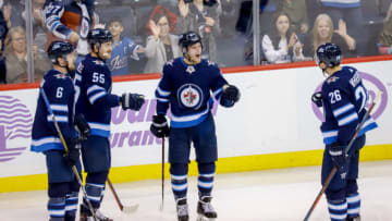WINNIPEG, MB - NOVEMBER 29: Cameron Schilling #6, Mark Scheifele #55, Nikolaj Ehlers #27 and Blake Wheeler #26 of the Winnipeg Jets celebrate a second period goal against the Chicago Blackhawks at the Bell MTS Place on November 29, 2018 in Winnipeg, Manitoba, Canada. (Photo by Darcy Finley/NHLI via Getty Images)