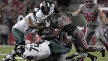 Nov. 11, 2023; Columbus, Oh., USA;Michigan State Spartans tight end Maliq Carr (6) is tackled by Ohio State Buckeyes cornerback Calvin Simpson-Hunt (15) and Ohio State Buckeyes linebacker C.J. Hicks (11) during Saturday's NCAA Division I football game at Ohio Stadium.