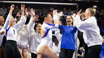 Florida Gators gymnast Leanne Wong is congratulated by teammates after her uneven bar routine. The Florida women's gymnastic team hosted the Georgia Bulldogs at Exactech Arena at the Stephen C. O’Connell Center in Gainesville, FL on Friday, January 27, 2023. Florida defeated Georgia 197.900 to 196.850. [Doug Engle/Ocala Star Banner]Flgai 012923 Uga Uf Gym
