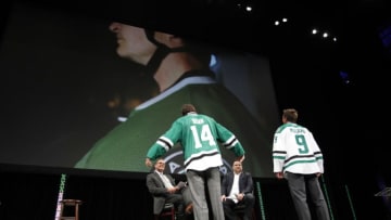 DALLAS, TX - JUNE 4: Jamie Benn and Mike Modano model the new jerseys at the Dallas Stars unveiling of their new logo and uniforms during a ceremony at the AT&T Performing Arts Center on June 4, 2013 in Dallas, Texas. (Photo by Glenn James/NHLI via Getty Images)