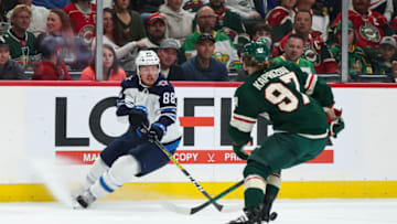 Oct 19, 2021; Saint Paul, Minnesota, USA; Winnipeg Jets defenseman Nate Schmidt (88) skates with the puck while Minnesota Wild left wing Kirill Kaprizov (97) defends in the first period at Xcel Energy Center. Mandatory Credit: David Berding-USA TODAY Sports