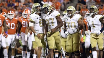 CLEMSON, SOUTH CAROLINA - AUGUST 29: Quarterback Tobias Oliver #8 celebrates with running back Jordan Mason #27 of the Georgia Tech Yellow Jackets after Mason's touchdown in the third quarter of their football game against the Clemson Tigers at Memorial Stadium on August 29, 2019 in Clemson, South Carolina. (Photo by Mike Comer/Getty Images)