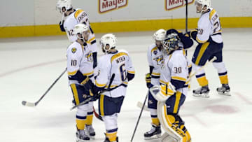 Nashville Predators goalie Carter Hutton (30) is consoled by defenseman Shea Weber (6) and center Colton Sissons (10) after game seven of the second round of the 2016 Stanley Cup Playoffs. Mandatory Credit: Neville E. Guard-USA TODAY Sports