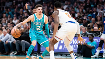 CHARLOTTE, NORTH CAROLINA - MARCH 23: LaMelo Ball #2 of the Charlotte Hornets brings the ball up court while guarded by RJ Barrett #9 of the New York Knicks in the third quarter at Spectrum Center on March 23, 2022 in Charlotte, North Carolina. NOTE TO USER: User expressly acknowledges and agrees that, by downloading and or using this photograph, User is consenting to the terms and conditions of the Getty Images License Agreement. (Photo by Jacob Kupferman/Getty Images)