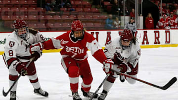 BOSTON - FEBRUARY 12: Boston University's Jesse Compher (7, center) battles with Harvard's Kate Glover (8) and Lunasa Sano for control of the puck during the first period. Boston University meets Harvard University in the Women's Beanpot Championship Game at the Bright-Landry Hockey Center in Boston on Feb. 12, 2019. (Photo by Matthew J. Lee/The Boston Globe via Getty Images)
