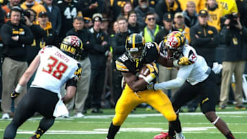 Oct 31, 2015; Iowa City, IA, USA; Iowa Hawkeyes running back Derrick Mitchell Jr. (32) is tackled by Maryland Terrapins linebacker Brett Zanotto (38) and a teammate during the first half at Kinnick Stadium. Mandatory Credit: Jeffrey Becker-USA TODAY Sports