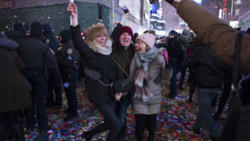 Revelers celebrate as the ball drops to welcome in the new year during New Year's Eve celebrations in Times Square on January 1, 2018 in New York. / AFP PHOTO / DON EMMERT (Photo credit should read DON EMMERT/AFP/Getty Images)