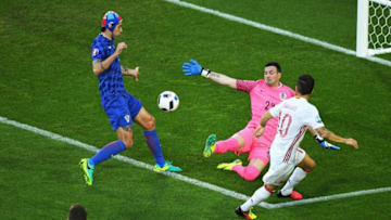 BORDEAUX, FRANCE - JUNE 21: Cesc Febregas (R) of Spain kicks the ball to set up the opening goal by Alvaro Morata (not pictured) during the UEFA EURO 2016 Group D match between Croatia and Spain at Stade Matmut Atlantique on June 21, 2016 in Bordeaux, France. (Photo by Dennis Grombkowski/Getty Images)