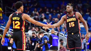 ORLANDO, FLORIDA - FEBRUARY 16: De'Andre Hunter #12 and Clint Capela #15 of the Atlanta Hawks high five during a game against the Orlando Magic at Amway Center on February 16, 2022 in Orlando, Florida. NOTE TO USER: User expressly acknowledges and agrees that, by downloading and or using this photograph, User is consenting to the terms and conditions of the Getty Images License Agreement. (Photo by Julio Aguilar/Getty Images)
