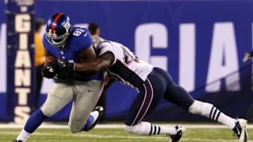 August 29, 2012; East Rutherford, NJ, USA; New York Giants tight end Adrien Robinson (81) is brought down by New England Patriots defensive back James Ihedigbo (44) during the third quarter of a preseason game at MetLife Stadium. Mandatory Credit: Brad Penner-USA TODAY Sports