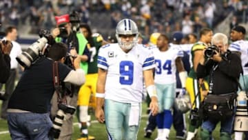Dec 15, 2013; Arlington, TX, USA; Dallas Cowboys quarterback Tony Romo (9) walks off the field as photographers capture images after the game against the Green Bay Packers at AT&T Stadium. The Packers beat the Cowboys 37-36. Mandatory Credit: Matthew Emmons-USA TODAY Sports