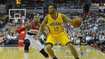 May 9, 2014; Washington, DC, USA; Indiana Pacers small forward Evan Turner (12) dribbles the ball as Washington Wizards shooting guard Bradley Beal (3) defends during the first half in game three of the second round of the 2014 NBA Playoffs at Verizon Center. Mandatory Credit: Brad Mills-USA TODAY Sports