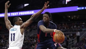 Apr 12, 2015; Auburn Hills, MI, USA; Detroit Pistons guard Reggie Jackson (1) makes a pass around Charlotte Hornets forward Noah Vonleh (11) during the fourth quarter at The Palace of Auburn Hills. Pistons beat the Hornets 116-77. Mandatory Credit: Raj Mehta-USA TODAY Sports