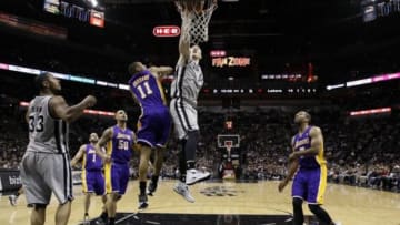 Mar 14, 2014; San Antonio, TX, USA; San Antonio Spurs forward Aron Baynes (16) dunks the ball past Los Angeles Lakers forward Wesley Johnson (11) during the first half at AT&T Center. Mandatory Credit: Soobum Im-USA TODAY Sports