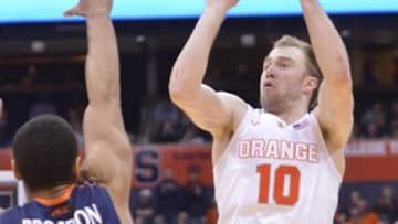 Mar 2, 2015; Syracuse, NY, USA; Syracuse Orange guard Trevor Cooney (10) takes a jump shot over Virginia Cavaliers guard Malcolm Brogdon (15) during the second half of a game at the Carrier Dome. Virginia won the game 59-47. Mandatory Credit: Mark Konezny-USA TODAY Sports