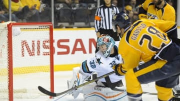 Feb 17, 2015; Nashville, TN, USA; Nashville Predators center Paul Gaustad (28) scores past San Jose Sharks goalie Alex Stalock (32) during the second period at Bridgestone Arena. Mandatory Credit: Christopher Hanewinckel-USA TODAY Sports