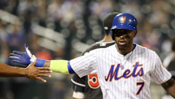 Sep 1, 2016; New York City, NY, USA; New York Mets shortstop Jose Reyes (7) high fives first base coach Tom Goodwin after getting a base hit against the Miami Marlins at Citi Field. Mandatory Credit: Wendell Cruz-USA TODAY Sports