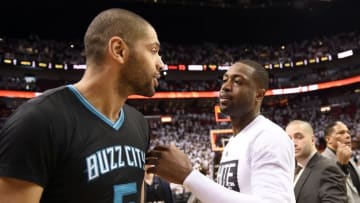 May 1, 2016; Miami, FL, USA; Miami Heat guard Dwyane Wade (right) greets Charlotte Hornets guard Nicolas Batum (left) after game seven of the first round of the NBA Playoffs at American Airlines Arena. The Heat won 106-73. Mandatory Credit: Steve Mitchell-USA TODAY Sports