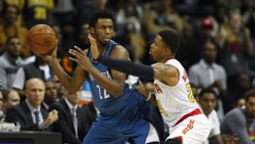 Nov 9, 2015; Atlanta, GA, USA; Minnesota Timberwolves guard Andrew Wiggins (22) is defended by Atlanta Hawks guard Kent Bazemore (24) in the fourth quarter at Philips Arena. The Timberwolves defeated the Hawks 117-107. Mandatory Credit: Brett Davis-USA TODAY Sports