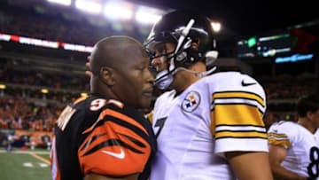 Sep 16, 2013; Cincinnati, OH, USA; Cincinnati Bengals outside linebacker James Harrison (92) hugs Pittsburgh Steelers quarterback Ben Roethlisberger (7) after the Cincinnati Bengals defeated the Pittsburgh Steelers 20-10 at Paul Brown Stadium. Mandatory Credit: Andrew Weber-USA TODAY Sports