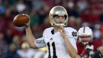Nov 30, 2013; Stanford, CA, USA; Notre Dame Fighting Irish quarterback Tommy Rees (11) throws the ball against the Stanford Cardinal during the second quarter at Stanford Stadium. Mandatory Credit: Kelley L Cox-USA TODAY Sports