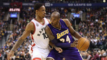 Dec 7, 2015; Toronto, Ontario, CAN; Los Angeles Lakers guard Kobe Bryant (24) goes up against Toronto Raptors guard DeMar DeRozan (10) at Air Canada Centre. The Raptors beat the Lakers 102-93. Mandatory Credit: Tom Szczerbowski-USA TODAY Sports