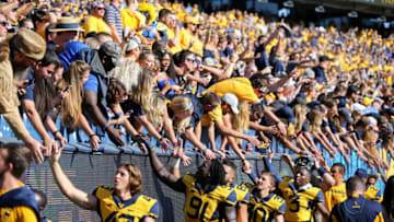 MORGANTOWN, WV - OCTOBER 14: West Virginia Mountaineers players celebrate with the student section following the scollege football game between the Texas Tech Red Raiders and the West Virginia Mountaineers on October 14, 2017, at Mountaineer Field at Milan Puskar Stadium in Morgantown, WV. (Photo by Frank Jansky/Icon Sportswire via Getty Images)