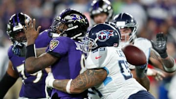 BALTIMORE, MD - JANUARY 11: Jurrell Casey #99 of the Tennessee Titans tackles quarterback Lamar Jackson #8 of the Baltimore Ravens to cause a fumble during the third quarter of the AFC Divisional Playoff game at M&T Bank Stadium on January 11, 2020 in Baltimore, Maryland. (Photo by Todd Olszewski/Getty Images)