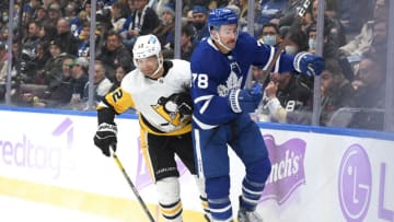 Nov 20, 2021; Toronto, Ontario, CAN; Toronto Maple Leafs defenseman TJ Brodie (78) is bodychecked off the puck by Pittsburgh Penguins forward Zach Aston-Reese (12) in the third period at Scotiabank Arena. Mandatory Credit: Dan Hamilton-USA TODAY Sports