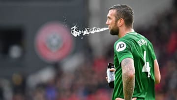 Brighton's Irish defender Shane Duffy spits out some water during a break in play in the English Premier League football match between Sheffield United and Brighton and Hove Albion at Bramall Lane in Sheffield, northern England on February 22, 2020. (Photo by Paul ELLIS / AFP) / RESTRICTED TO EDITORIAL USE. No use with unauthorized audio, video, data, fixture lists, club/league logos or 'live' services. Online in-match use limited to 120 images. An additional 40 images may be used in extra time. No video emulation. Social media in-match use limited to 120 images. An additional 40 images may be used in extra time. No use in betting publications, games or single club/league/player publications. / (Photo by PAUL ELLIS/AFP via Getty Images)