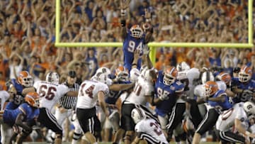 Florida defensive end Jarvis Moss (94) leaps to block a last-second attempt at a game-winning field goal by South Carolina kicker Ryan Succop Nov. 11, 2006 in Gainesville. Florida won 17 - 16. (Photo by A. Messerschmidt/Getty Images)