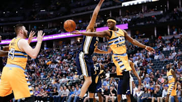 Apr 10, 2016; Denver, CO, USA; Denver Nuggets guard Emmanuel Mudiay (0) passes the ball to center Jusuf Nurkic (23) around Utah Jazz center Rudy Gobert (27) in the third quarter at the Pepsi Center. The Jazz defeated the Nuggets 100-84. Mandatory Credit: Isaiah J. Downing-USA TODAY Sports