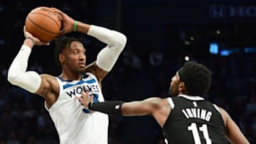 NEW YORK, NEW YORK - OCTOBER 23: Kyrie Irving #11 of the Brooklyn Nets guards Robert Covington #33 of the Minnesota Timberwolves. (Photo by Emilee Chinn/Getty Images)