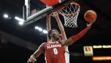 PORTLAND, OREGON - NOVEMBER 24: Jaden Bradley #0 of the Alabama Crimson Tide shoots under pressure from Carson Cooper #15 of the Michigan State Spartans during the second half at Moda Center on November 24, 2022 in Portland, Oregon. (Photo by Soobum Im/Getty Images)