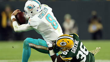 GREEN BAY, WI - NOVEMBER 11: Brock Osweiler #8 of the Miami Dolphins is sacked by Raven Greene #36 of the Green Bay Packers during the second half of a game at Lambeau Field on November 11, 2018 in Green Bay, Wisconsin. (Photo by Dylan Buell/Getty Images)