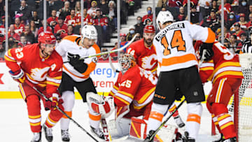 CALGARY, AB - OCTOBER 30: Sean Couturier #14 of the Philadelphia Flyers takes a shot on the net of Jacob Markstrom #25 of the Calgary Flames during an NHL game at Scotiabank Saddledome on October 30, 2021 in Calgary, Alberta, Canada. (Photo by Derek Leung/Getty Images)