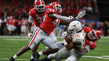 NEW ORLEANS, LOUISIANA - JANUARY 01: Keaontay Ingram #26 of the Texas Longhorns is tackled by Jonathan Ledbetter #13 of the Georgia Bulldogs during the first half at the Mercedes-Benz Superdome on January 01, 2019 in New Orleans, Louisiana. (Photo by Sean Gardner/Getty Images)