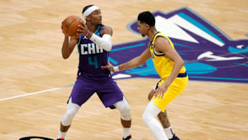 CHARLOTTE, NORTH CAROLINA - JANUARY 27: Devonte' Graham #4 of the Charlotte Hornets is closely guarded by Jeremy Lamb #26 of the Indiana Pacers during the third quarter of their game at Spectrum Center on January 27, 2021 in Charlotte, North Carolina. NOTE TO USER: User expressly acknowledges and agrees that, by downloading and or using this photograph, User is consenting to the terms and conditions of the Getty Images License Agreement. (Photo by Jared C. Tilton/Getty Images)