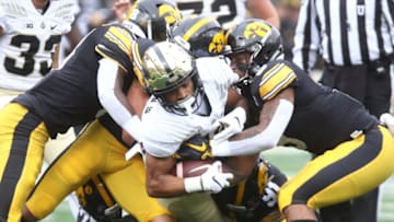IOWA CITY, IOWA- OCTOBER 19: Wide receiver Ahmad Anderson #10 of the Purdue Boilermakers is tackled in the first half by defensive backs Dane Belton #4 and Geno Stone #9 of the Iowa Hawkeyes, on October 19, 2019 at Kinnick Stadium in Iowa City, Iowa. (Photo by Matthew Holst/Getty Images)