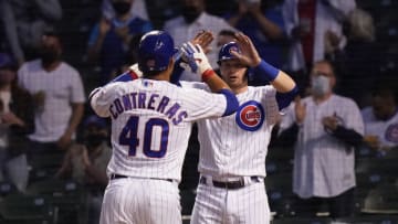 CHICAGO, ILLINOIS - APRIL 05: Willson Contreras #40 of the Chicago Cubs is congratulated by Ian Happ #8 following his two run home run during the fourth inning of a game against the Milwaukee Brewers at Wrigley Field on April 05, 2021 in Chicago, Illinois. (Photo by Nuccio DiNuzzo/Getty Images)