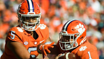 Nov 20, 2021; Clemson, South Carolina, USA; Clemson quarterback D.J. Uiagalelei (5) hands the ball to running back Will Shipley (1) during their game against Wake Forest at Memorial Stadium. Mandatory Credit: Josh Morgan-USA TODAY Sports