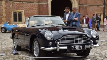 LONDON, ENGLAND - SEPTEMBER 02: Visitors view a 1965 Aston Martin DB5 Convertible classic car which Is displayed for auction with the Gooding and Company with an estimate of £1,250,000 - £1,750,000 during the Concours of Elegance at Hampton Court Palace on September 02, 2022 in London, England. The Concours of Elegance brings together a selection of the rarest cars from around the world, many of which, have never been seen before in the UK. (Photo by John Keeble/Getty Images)