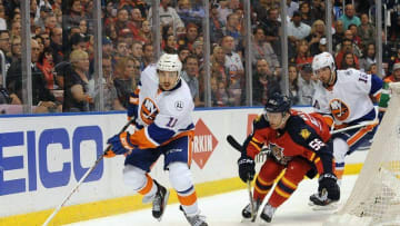 Apr 22, 2016; Sunrise, FL, USA; New York Islanders center Shane Prince (11) works the puck as Florida Panthers defenseman Michael Matheson (56) gives chase during first period action in game five of the first round of the 2016 Stanley Cup Playoffs at BB&T Center. Mandatory Credit: Robert Duyos-USA TODAY Sports