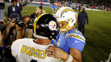 CARSON, CALIFORNIA - OCTOBER 13: Quarterback Devlin Hodges #6 of the Pittsburgh Steelers and quarterback Philip Rivers #17 of the Los Angeles Chargers greet each other following a game at Dignity Health Sports Park on October 13, 2019 in Carson, California. (Photo by Katharine Lotze/Getty Images)