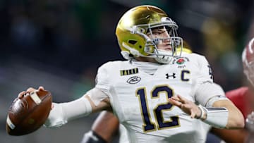 ARLINGTON, TEXAS - JANUARY 01: Quarterback Ian Book #12 of the Notre Dame Fighting Irish drops back to pass over the defense of the Alabama Crimson Tide during the third quarter of the 2021 College Football Playoff Semifinal Game at the Rose Bowl Game presented by Capital One at AT&T Stadium on January 01, 2021 in Arlington, Texas. (Photo by Tom Pennington/Getty Images)