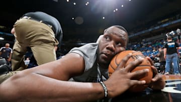 MINNEAPOLIS, MN - APRIL 15: Al Jefferson #25 of the Utah Jazz stretches with a trainer before playing against the Minnesota Timberwolves on April 15, 2013 at Target Center in Minneapolis, Minnesota. Copyright 2013 NBAE (Photo by David Sherman/NBAE via Getty Images)