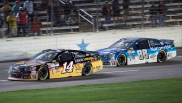 Apr 11, 2015; Fort Worth, TX, USA; Sprint Cup Series driver Tony Stewart (14) and driver Dale Earnhardt Jr. (88) during the Duck Commander 500 at Texas Motor Speedway. Mandatory Credit: Jerome Miron-USA TODAY Sports