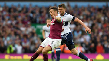 BIRMINGHAM, ENGLAND - MAY 15: James Chester of Aston Villa controls the ball as Jonny Howson of Middlesbrough chases during the Sky Bet Championship Play Off Semi Final second leg match between Aston Villa and Middlesbrough at Villa Park on May 15, 2018 in Birmingham, England. (Photo by Ross Kinnaird/Getty Images)
