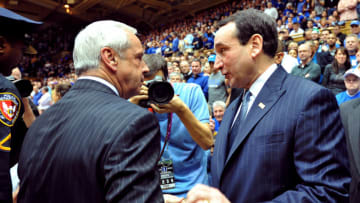 Duke basketball head coach Mike Krzyzewski and UNC's Roy Williamson (Photo by Lance King/Getty Images)